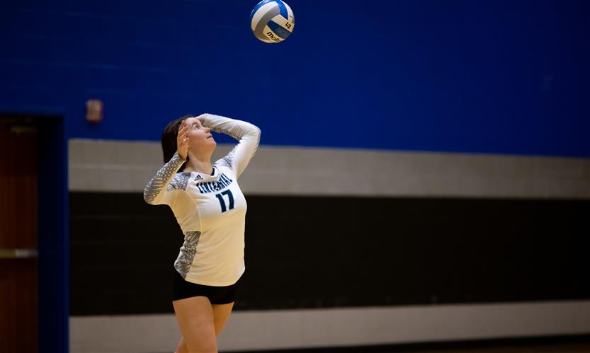 High school students play volleyball